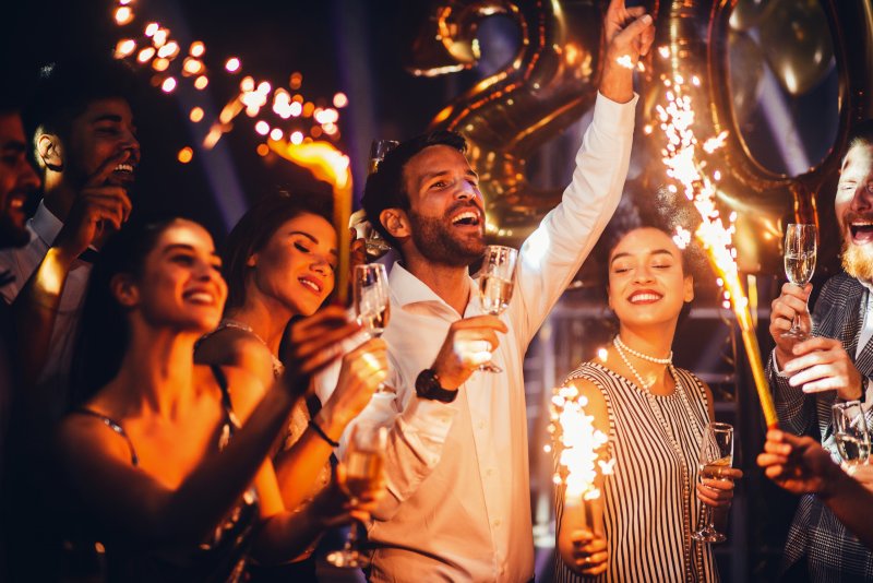 Patient smiling with friends at a New Year party